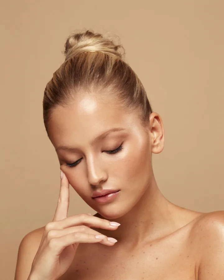 Woman touching her face, facial harmonization