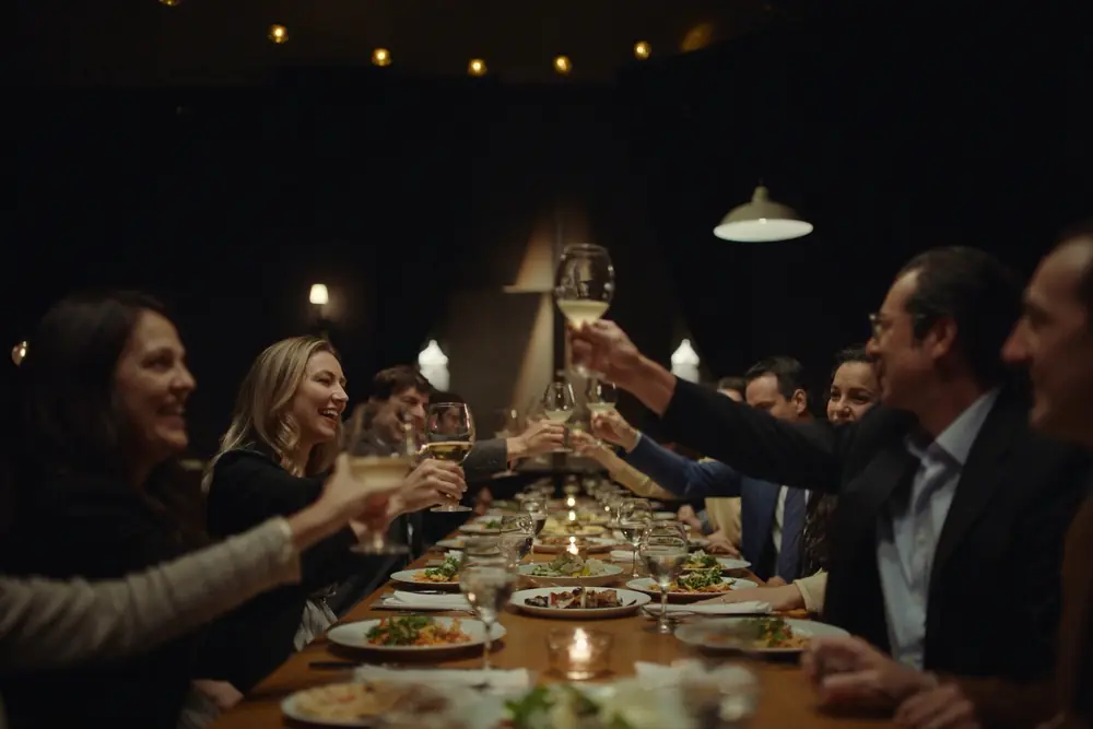 Members toasting at a candlelit dinner
