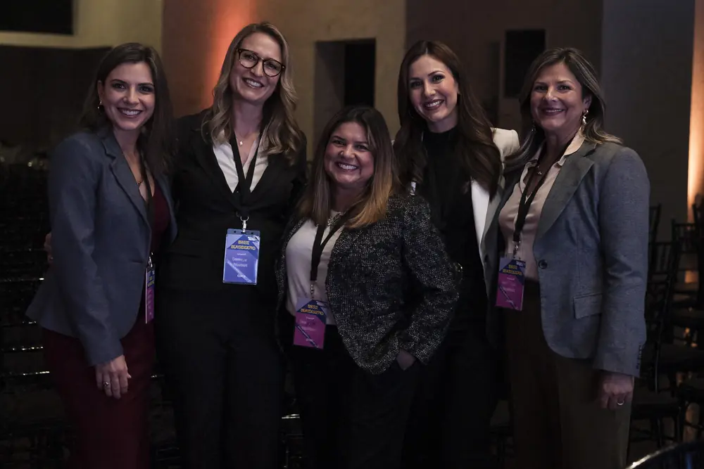 Five businesswomen posing together at a Patamar event